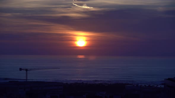 Sunset Timelapse With Buildings And A Construction Crane