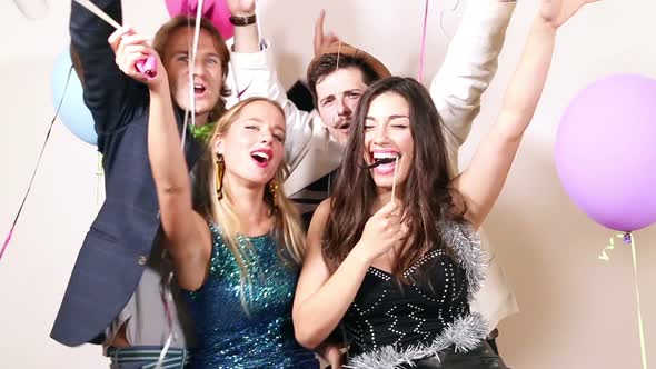 Friends laughing and enjoying in party photo booth