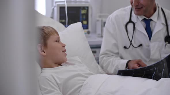 Doctor Explaining Little Boy X-Ray Results