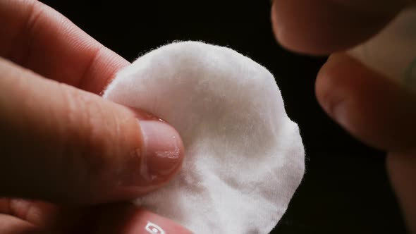 Person Sprays Antiseptic Onto Cotton Pad To Clean Germs