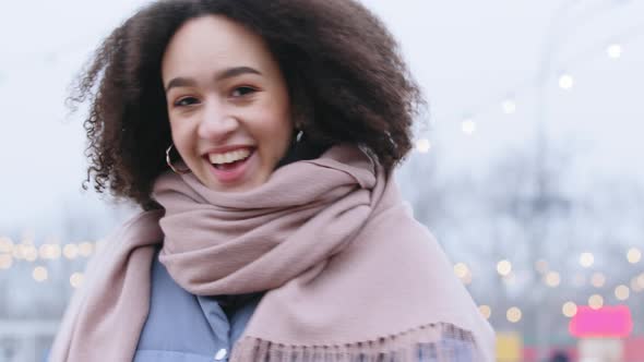 Portrait of Ethnic Mixed Race Millennial Girl Charming Woman with Afro Curls Spends Time Outdoors in