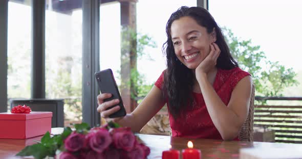 Happy biracial woman making valentine's day video call on tablet, sending kisses