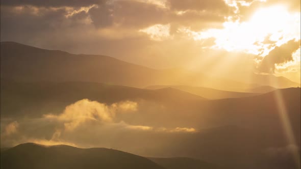 Amazing Sunset with Thick Flowing Clouds in the Caucasus Mountains