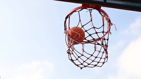 Shooting basketball ball into the basket in layup