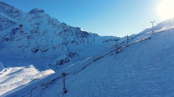 Empty Chairlifts Drive on Wire at Ski Resort on Mountain