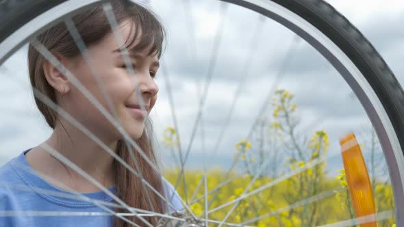 A child with a bicycle.