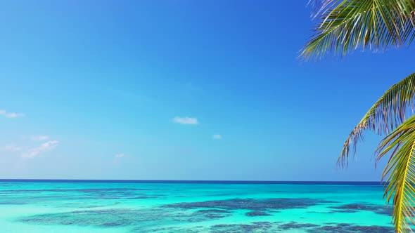 Wide aerial island view of a white sandy paradise beach and blue sea background in high resolution 4