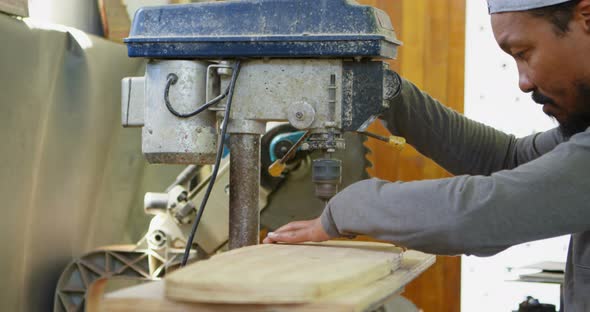 Man using radial drill machine