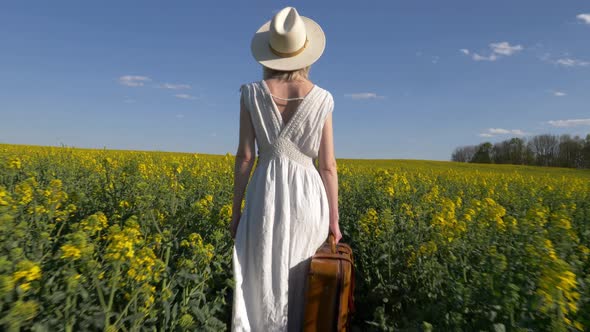 woman in white dress with suitcase and binocular