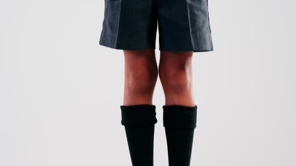 Excited schoolboy standing on stack of books