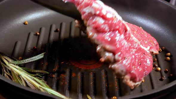 Juicy Meat Steak Is Turned on the Other Side for a Complete Frying.