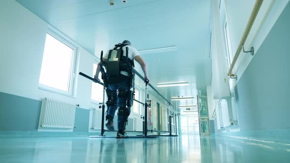 Disabled Man is Walking in the Exoskeleton in a Hospital
