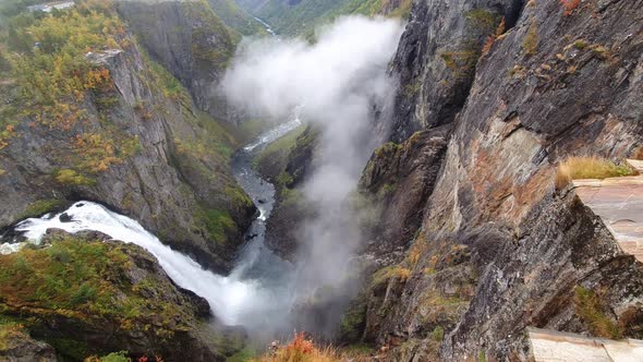 Galce into the depths of norway largest waterfall. along the impressive Valley of Voringfoss Waterfa