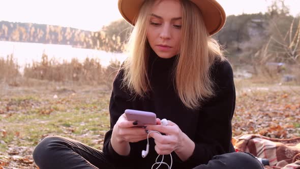 Millennial Woman Slow Motion Caucasian Blonde Woman with Beige Hat in Black Sweater Use Phone and