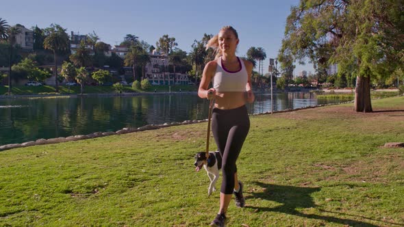 Attractive Woman Jogging With Her Dog