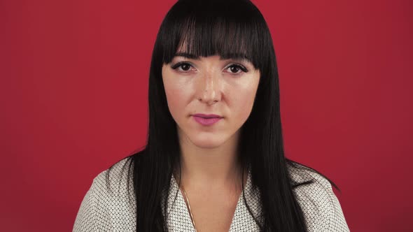 Portrait Of Surprised Amazed Adult Woman Over Red Background