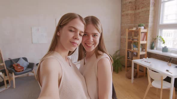 Happy Twin Girls Taking Selfie