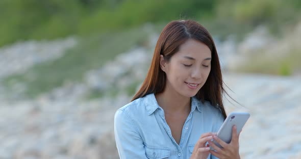 Woman Work on Mobile Phone at Seaside