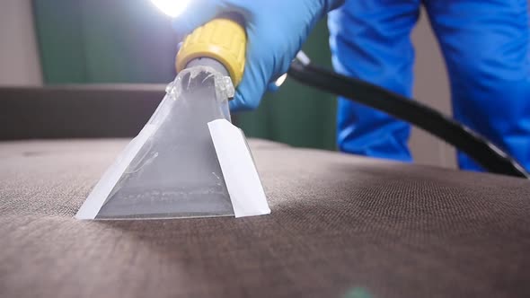 Cleanliness Concept. Dry Cleaning Worker Removing Dirt From Upholstered Furniture