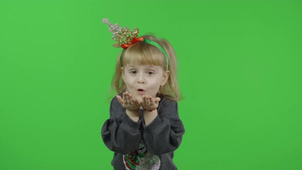 Happy Beautiful Little Girl in a Sweater with a Snowman. Christmas. Chroma Key