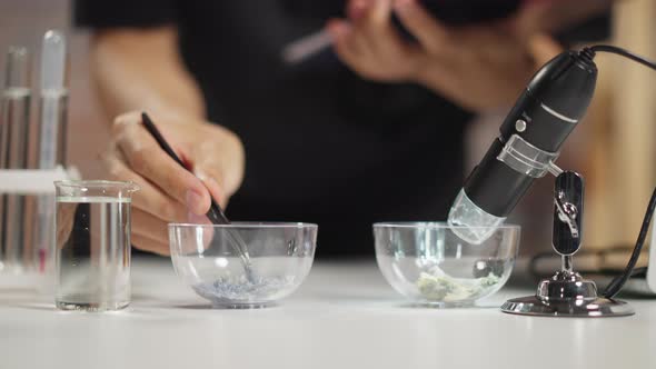 Chemist Takes Material with White Crystals in Laboratory