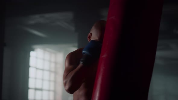 Male Fighter Boxing Punch Bag in Gym