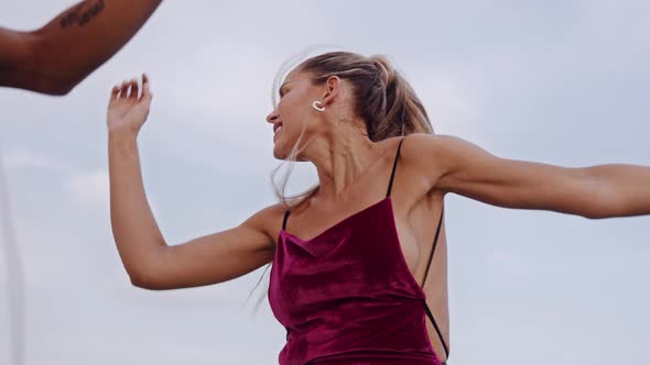 Blond Dancer Shaking Long Hair In Bright Clubwear On City Rooftop