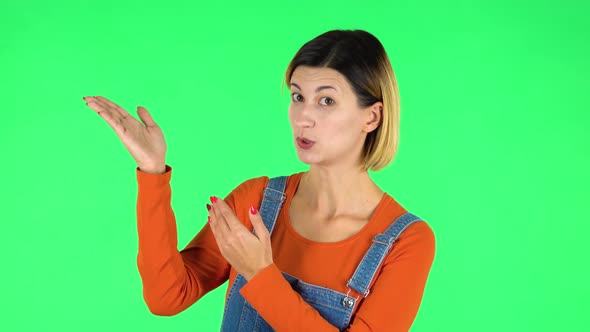 Woman Talking and Pointing Side Hand for Something, Copy Space. Green Screen