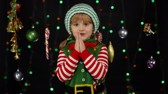 Christmas wish concept Little fun blonde kid teen teenager girl in Christmas elf Santa helper costu