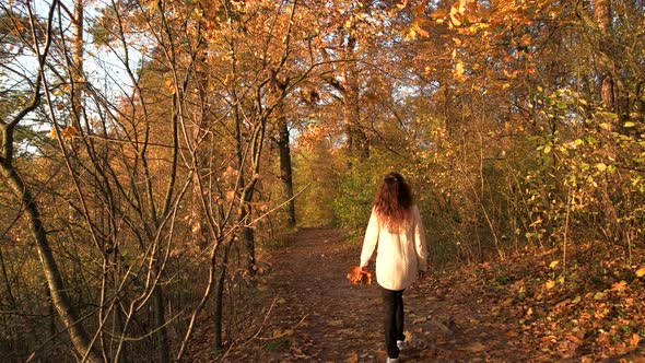 Woman Walking in Park Back View