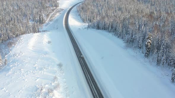 Highway Through the Winter Forest Aerial Photography From UAVs