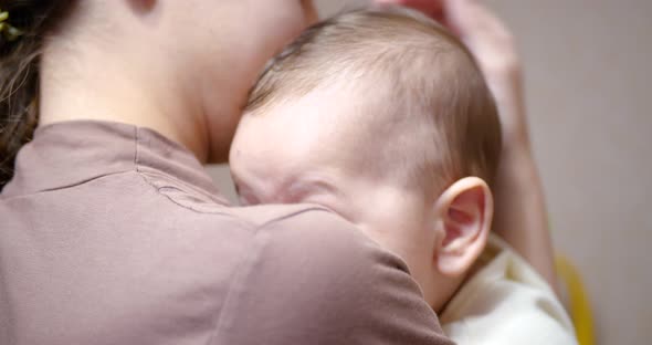 Baby in Mom's Arms Looking at the Camera