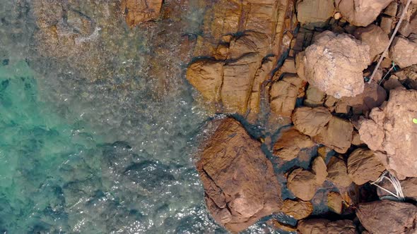 Camera Shoots Perfect Clear Blue Ocean with Huge Wet Stones