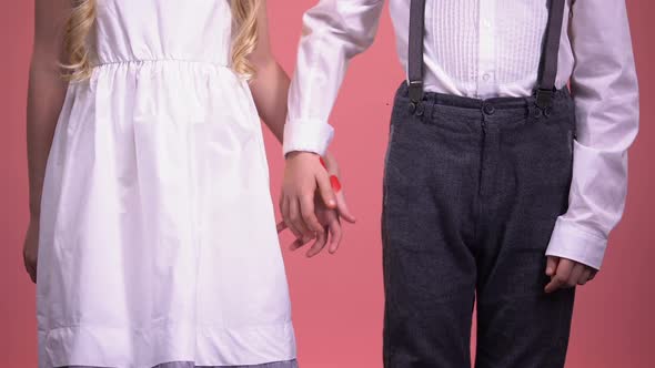 Cute Young Boy and Girl Holding Hands Close Up, First Love, Valentines Day