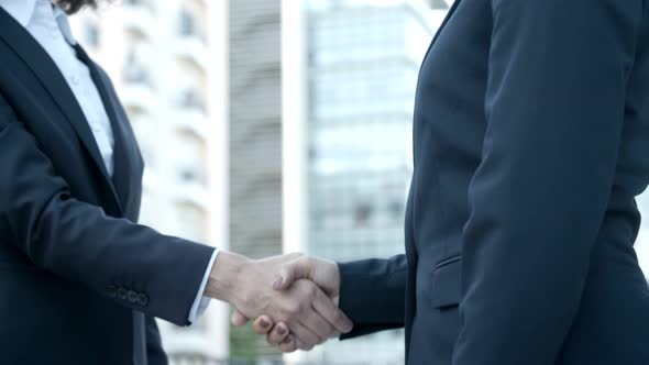 Two Businesswomen Shaking Hands on Street