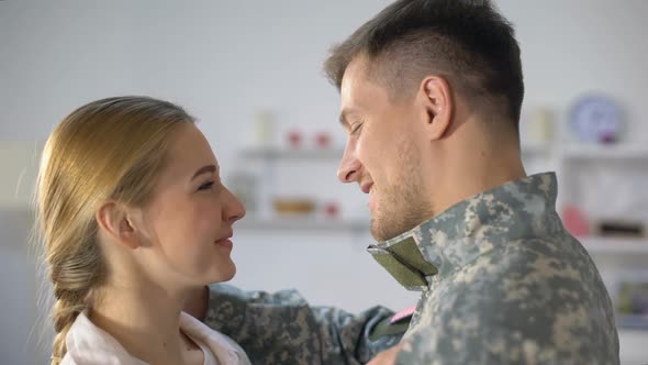 Cheerful Woman Hugging Loving Soldier Husband, Homecoming After War, Reunion