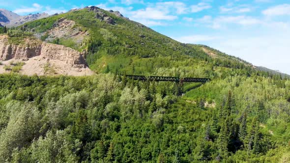 4K Drone Video of Train Trestle bridge and Mountains Rising above the Chulitna River near Denali Nat