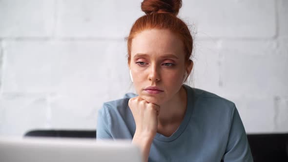 Close-up Face of Exhausted Sleepy Redhead Young Businesswoman Working on Laptop and with Documents.