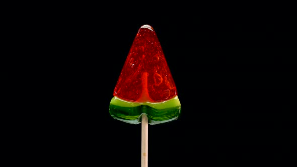 A Red Lollipop Is Spinning On A Black Background