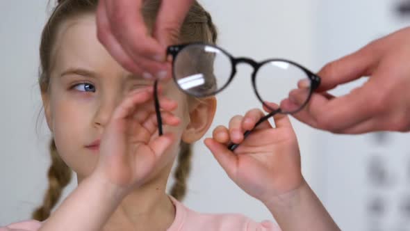 Little Girl Refusing Eyeglasses Offered by Doctor Child Insecurities, Healthcare