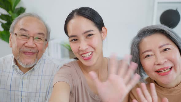 Asian lovely family, daughter use phone video call with senior parents.