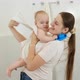 Smiling Mother Taking Her Baby Out of Bath and Wiping with Towel - VideoHive Item for Sale