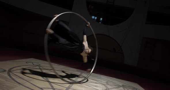Wheel Gymnastics Training Session Young Man Is Spinning in a Hoop