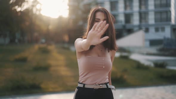 Portrait Slowmotion Video of Young Woman Looks Strictly to the Camera