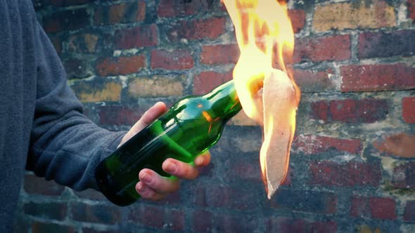Violent Protester Throws Burning Bottles In City