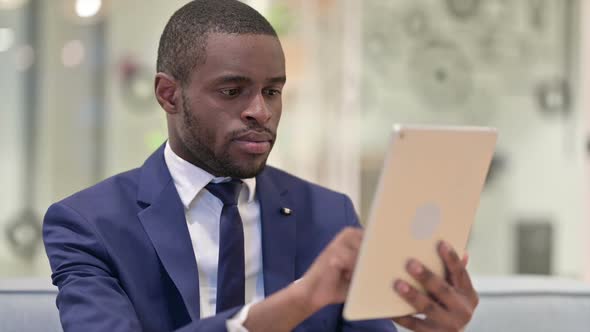 Portrait of African Businessman Using Digital Tablet