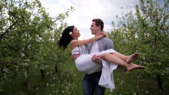 Happy Romantic Couple Dating in Blooming Orchard