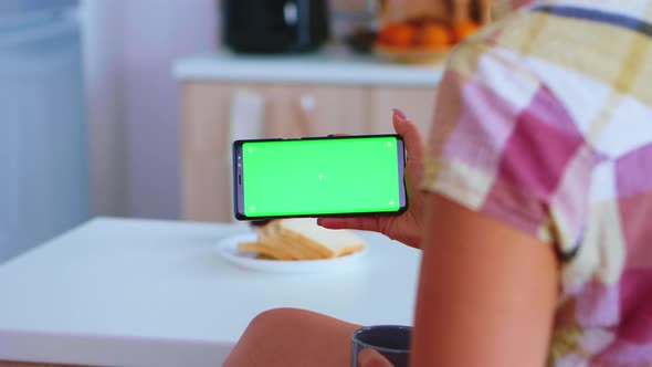Woman Watching a Phone with Green Screen