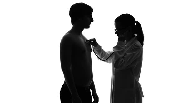 Female Therapist Examining Male Patient Chest With Stethoscope, Health Care