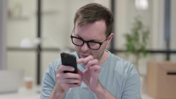 Portrait of Young Man Using Smartphone